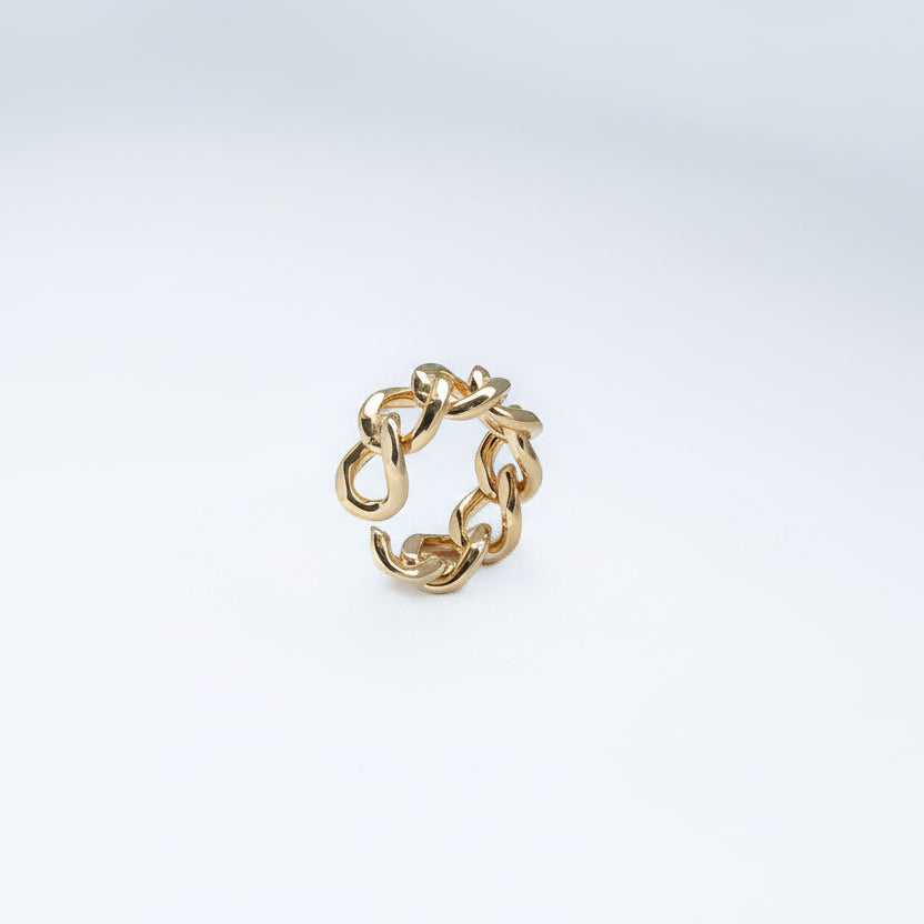 Gold chain ring on a light gray background